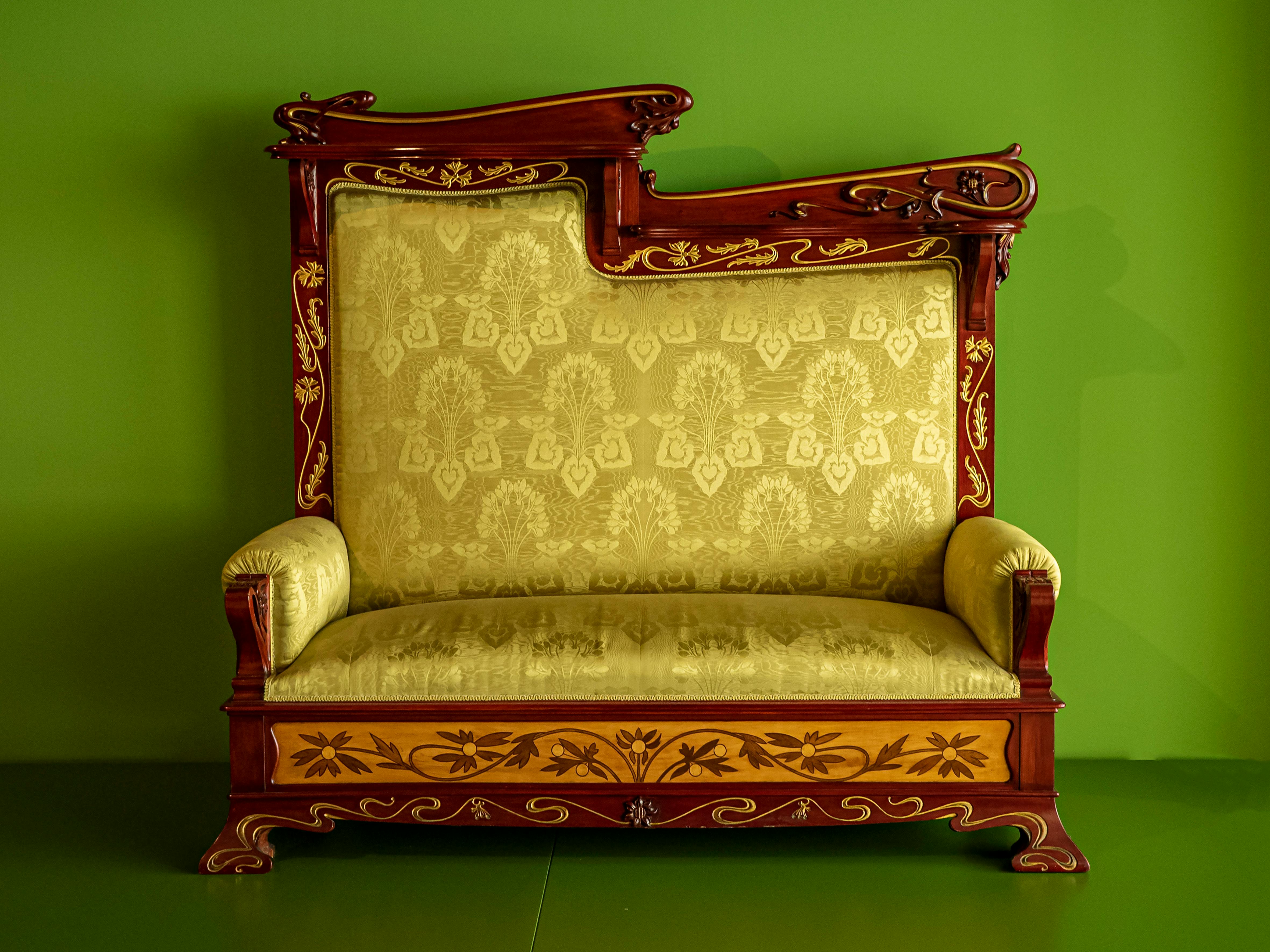 Ornate Sofa with Green Background